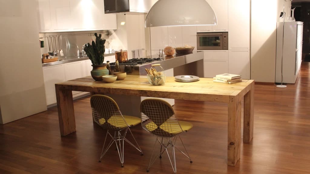 Modern open-plan kitchen with a wooden dining table